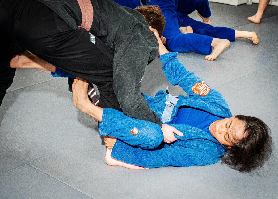 Abby training jiu jitsu on the mat